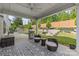 Inviting outdoor patio with comfortable seating, a built-in grill, and a fire pit, creating an ideal space for entertaining at 11209 Flenniken Ct, Charlotte, NC 28277