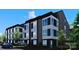 Modern three-story townhome with eye-catching dark gray exterior and white trim details at 113 Verbena Ne St # 11, Charlotte, NC 28217