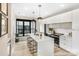 Modern kitchen with white cabinetry, stainless steel appliances, an island, and hardwood floors at 113 Verbena Ne St # 11, Charlotte, NC 28217