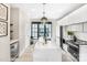 Stylish kitchen with white cabinets, large island with seating, and modern lighting fixtures at 113 Verbena Ne St # 11, Charlotte, NC 28217