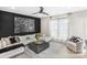 Modern living room with black accent wall, recessed lighting, and large window providing natural light at 113 Verbena Ne St # 11, Charlotte, NC 28217