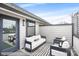Cozy outdoor patio with cushioned seating, string lights, and a striped outdoor rug at 113 Verbena Ne St # 11, Charlotte, NC 28217