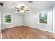 Bedroom featuring hardwood floors, gray walls, natural light from windows, and a ceiling fan at 114 Elmwood Dr, Salisbury, NC 28147