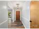 Welcoming entryway featuring hardwood floors, neutral paint, classic trim, and a charming light fixture at 114 Elmwood Dr, Salisbury, NC 28147