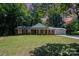Charming brick home featuring a well-manicured lawn and inviting front porch with classic white columns at 114 Elmwood Dr, Salisbury, NC 28147