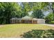 Charming brick home featuring a well-manicured lawn and inviting front porch with classic white columns at 114 Elmwood Dr, Salisbury, NC 28147