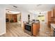 Open kitchen with cooktop island, stainless oven, and dining area with backyard access at 114 Elmwood Dr, Salisbury, NC 28147