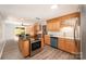 Well-lit kitchen with stainless steel appliances, wooden cabinets, and island cooktop at 114 Elmwood Dr, Salisbury, NC 28147