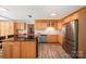 Bright kitchen with hardwood floors, wooden cabinets, stainless steel appliances, and a breakfast bar island at 114 Elmwood Dr, Salisbury, NC 28147