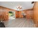 Spacious living room with wood-paneled walls and sliding doors to the backyard at 114 Elmwood Dr, Salisbury, NC 28147