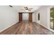 Spacious living room featuring hardwood floors, a modern ceiling fan, and sliding barn doors leading to another room at 114 Elmwood Dr, Salisbury, NC 28147