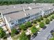 Aerial view of modern townhomes featuring blue and grey exteriors, complemented by lush green landscaping at 1142 Doveridge St, Charlotte, NC 28273