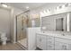 Bathroom featuring glass enclosed shower, modern double sink vanity with good lighting at 1142 Doveridge St, Charlotte, NC 28273