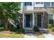 Attractive townhome entrance featuring a blue front door and manicured landscaping at 1142 Doveridge St, Charlotte, NC 28273