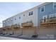 Exterior row of townhomes with brick facade, wood-tone balconies, and individual garage doors at 1142 Doveridge St, Charlotte, NC 28273