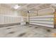 Spacious garage with room for storage and vehicle parking; door partially open and drywall ready for finishing at 1142 Doveridge St, Charlotte, NC 28273