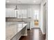 Bright kitchen features white cabinetry, stainless appliances, granite countertops, and hardwood flooring at 1142 Doveridge St, Charlotte, NC 28273
