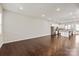 Open-concept living area with hardwood floors flowing into the modern kitchen with stainless steel appliances at 1142 Doveridge St, Charlotte, NC 28273