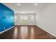 Bright living room with hardwood floors, recessed lighting, and striking blue accent wall at 1142 Doveridge St, Charlotte, NC 28273