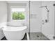 Elegant bathroom featuring a modern tub and a spacious glass shower at 12711 Duncourtney Ln, Charlotte, NC 28277