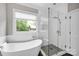 Spa-like bathroom with a freestanding tub and glass-enclosed shower at 12711 Duncourtney Ln, Charlotte, NC 28277