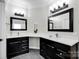 Beautiful bathroom with a double sink vanity, black cabinets, and modern lighting at 12711 Duncourtney Ln, Charlotte, NC 28277