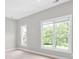 Bright bedroom featuring neutral walls, carpet, and two large windows with nice outdoor views at 12711 Duncourtney Ln, Charlotte, NC 28277