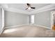 Calming bedroom with soft carpet, neutral walls, and a tray ceiling at 12711 Duncourtney Ln, Charlotte, NC 28277