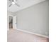 A neutral bedroom with a door leading to stairs and carpeted floor at 12711 Duncourtney Ln, Charlotte, NC 28277