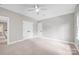 Spacious bedroom featuring neutral walls, plush carpet, white trim, and two closets for ample storage at 12711 Duncourtney Ln, Charlotte, NC 28277