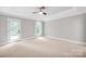 Serene bedroom with a tray ceiling, neutral carpet, and plenty of natural light at 12711 Duncourtney Ln, Charlotte, NC 28277