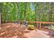 Beautiful backyard deck surrounded by lush greenery and trees at 12711 Duncourtney Ln, Charlotte, NC 28277