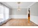 Elegant dining room with hardwood floors, chandelier, and abundant natural light at 12711 Duncourtney Ln, Charlotte, NC 28277