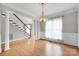 Elegant dining room with hardwood floors, chandelier, and abundant natural light at 12711 Duncourtney Ln, Charlotte, NC 28277