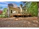 Exterior home view with a wooden deck and lush green landscaping at 12711 Duncourtney Ln, Charlotte, NC 28277