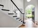 Welcoming foyer with wood floors, staircase and arched window providing natural light at 12711 Duncourtney Ln, Charlotte, NC 28277