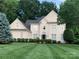 Traditional home featuring manicured lawn, lush landscaping, and charming architectural details at 12711 Duncourtney Ln, Charlotte, NC 28277