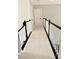 Hallway with modern black and white banister and neutral carpet at 12711 Duncourtney Ln, Charlotte, NC 28277