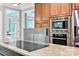 Gourmet kitchen features stainless steel appliances, granite countertops, and island cooktop at 12711 Duncourtney Ln, Charlotte, NC 28277