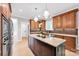 Well-appointed kitchen with a center island, custom cabinetry, and modern lighting fixtures at 12711 Duncourtney Ln, Charlotte, NC 28277