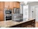 Modern kitchen with granite counters, stainless appliances, and sleek cooktop on the island at 12711 Duncourtney Ln, Charlotte, NC 28277