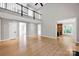 Open concept living area featuring hardwood floors, a balcony, and abundant natural light at 12711 Duncourtney Ln, Charlotte, NC 28277