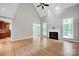 Large living room with fireplace, hardwood floors and access to kitchen at 12711 Duncourtney Ln, Charlotte, NC 28277