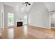 Spacious living room with a fireplace, hardwood floors, and ample natural light from the windows at 12711 Duncourtney Ln, Charlotte, NC 28277