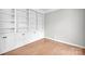 Office room featuring built in bookshelves and stylish hardwood flooring at 12711 Duncourtney Ln, Charlotte, NC 28277