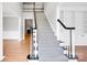Stylish staircase with herringbone carpet runner, contrasting dark handrail, and open floor plan at 12711 Duncourtney Ln, Charlotte, NC 28277