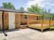 Brick house featuring a freshly built wooden deck and spacious backyard at 1306 Abbey Ct, Lancaster, SC 29720