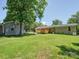 Well-manicured backyard with brick home, wooden deck, and detached building at 1306 Abbey Ct, Lancaster, SC 29720
