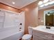 Clean bathroom featuring a tub, shower combo, vanity, modern fixtures, and neutral paint at 1306 Abbey Ct, Lancaster, SC 29720