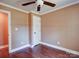 Comfortable bedroom featuring hardwood floors, a ceiling fan, and neutral walls at 1306 Abbey Ct, Lancaster, SC 29720